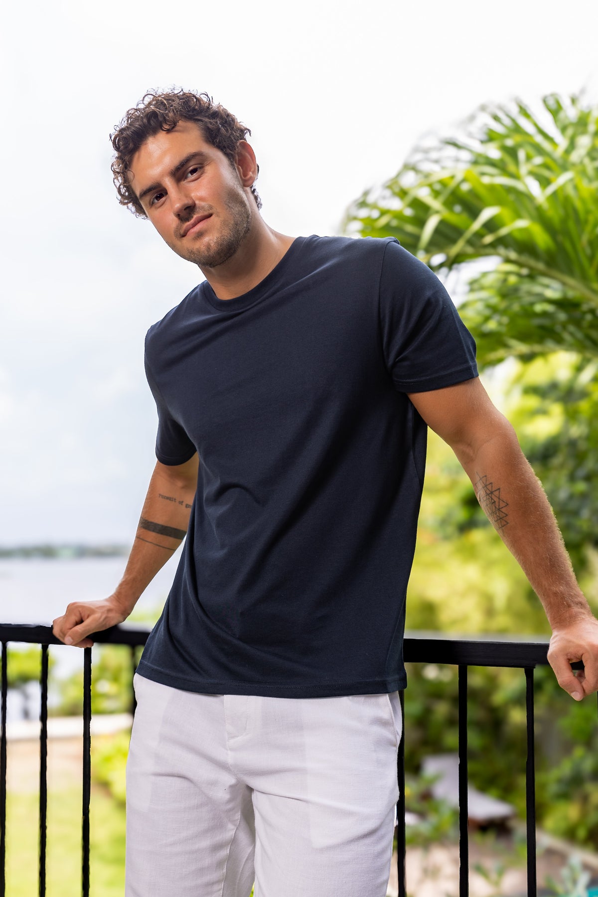 Navy tee on a balcony