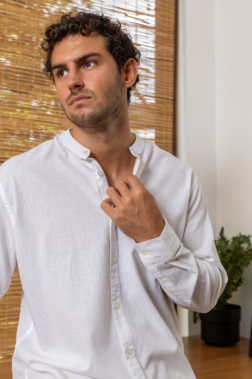 Man in a white Chinese-collar linen shirt